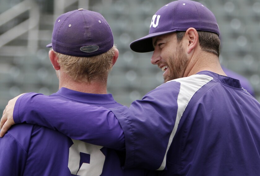 File-This May 28, 2014, file photo shows TCU baseball assistant coach Kirk Saarloos, right, talking with sophomore outfielder Boomer White (8) during practice, in Fort Worth, Texas. Former big league pitcher Saarloos was named TCU's new head baseball coach Tuesday, June 15, 2021, after nine seasons as the team's pitching coach that included four consecutive trips to the College World Series. Saarloos replaces Jim Schlossnagle, who left after 18 seasons last week to become Texas A&M's coach. (Brandon Wade /Star-Telegram via AP, File)
