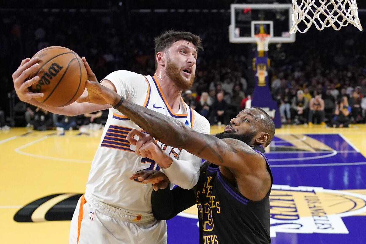 LeBron James blocks a pass attempt by Jusuf Nurkic.