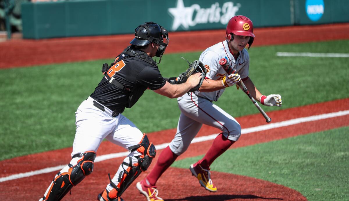 USC's Jack Basseer, right, is tagged out by Oregon State catcher Wilson Weber.