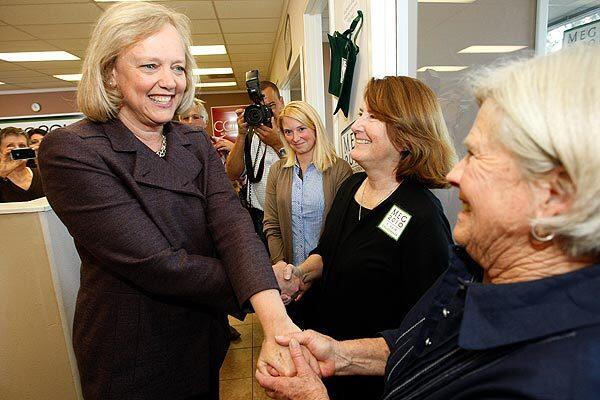 Meg Whitman greets volunteers Carol Hunt, center, and Priscilla Regur, right, at her campaign office in Woodland Hills. She dismissed polls and pundits showing her trailing in the governor's race.
