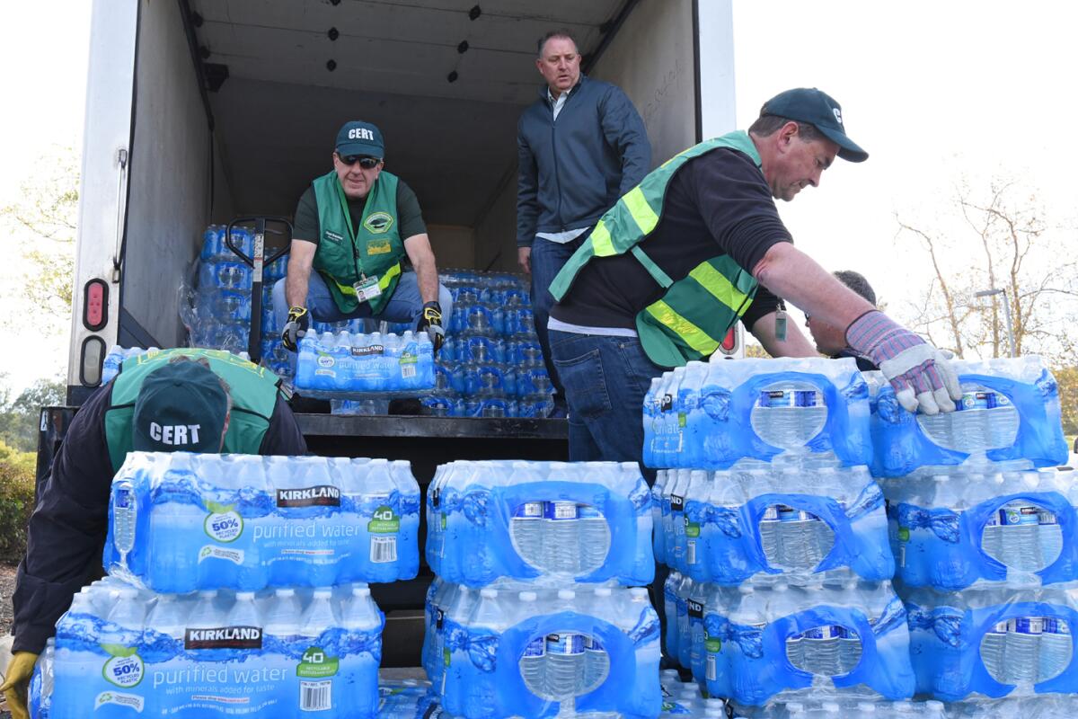 Poway CERT members unload bottled water to be distributed Sunday morning at Lake Poway.