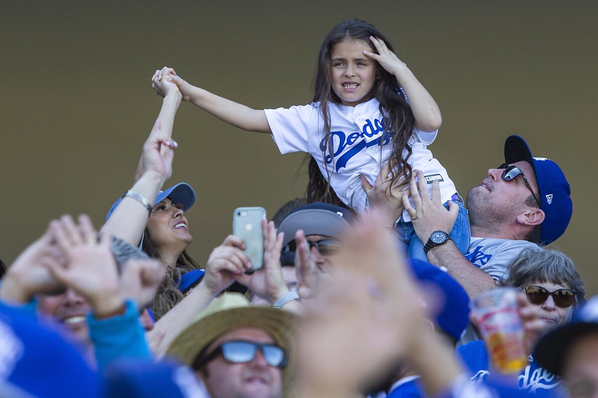 Dodgers fans celebrate Cody Bellinger's seventh inning home run on opening day.