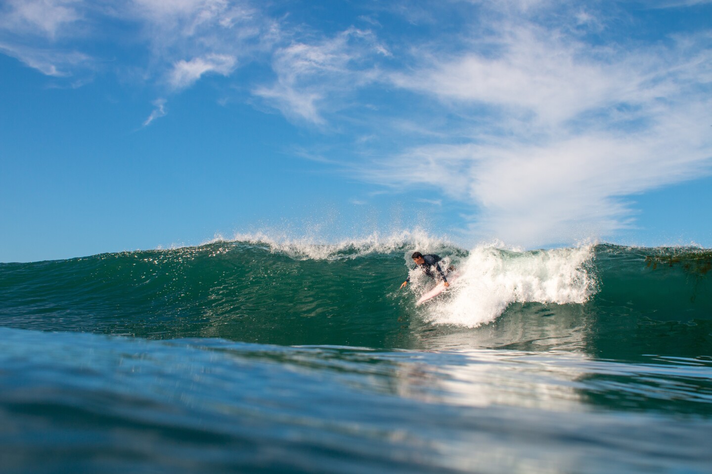 Summer's official start is about a month away, but surfing is always in season off Point Loma and Ocean Beach.