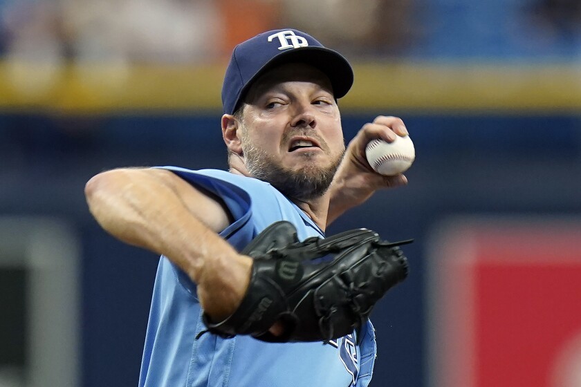 Tampa Bay Rays' Rich Hill goes into his windup against the Baltimore Orioles during the first inning of a baseball game Saturday, June 12, 2021, in St. Petersburg, Fla. (AP Photo/Chris O'Meara)
