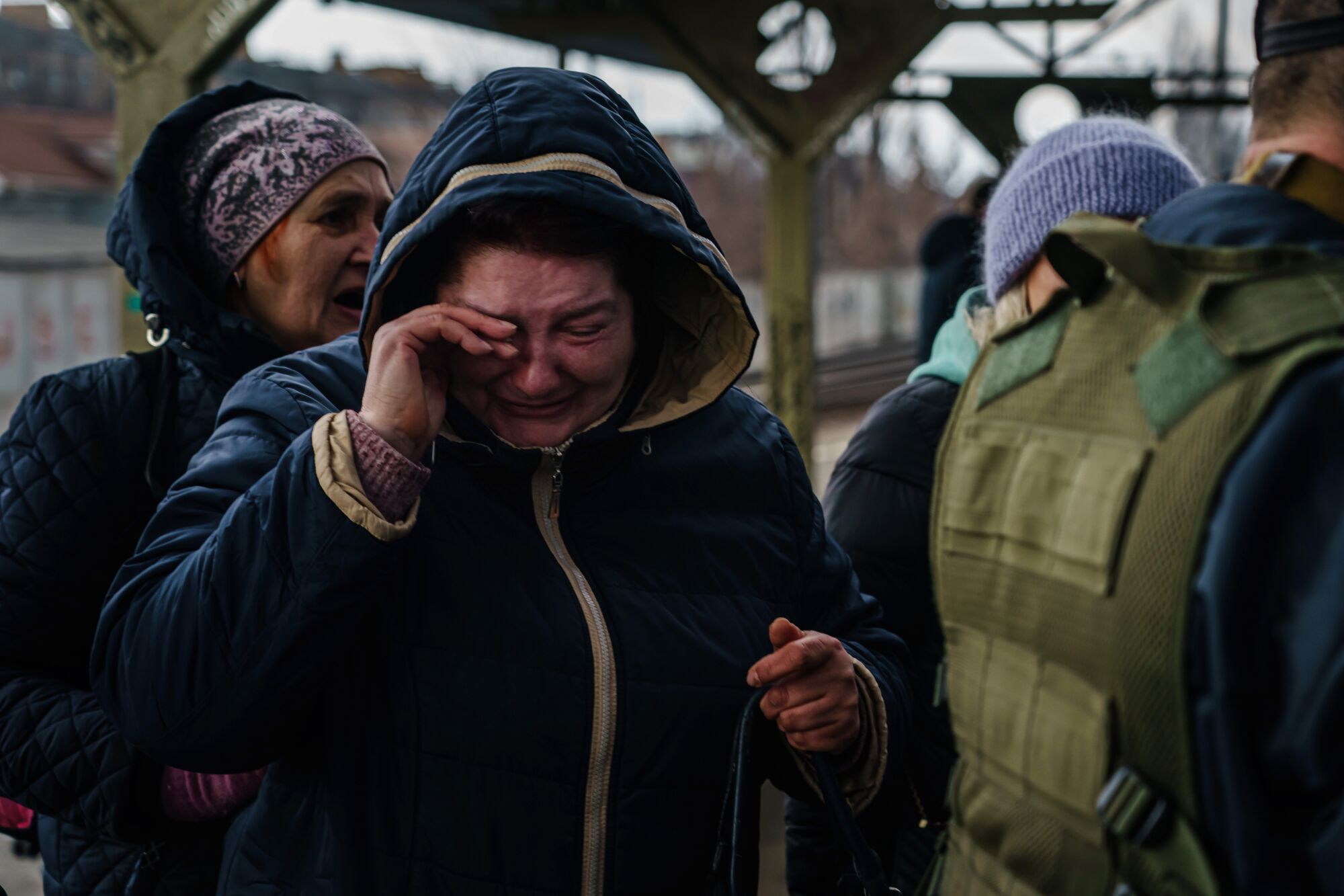 A woman breaks down in tears as she realizes she is getting to board an evacuating train in Irpin, Ukraine.
