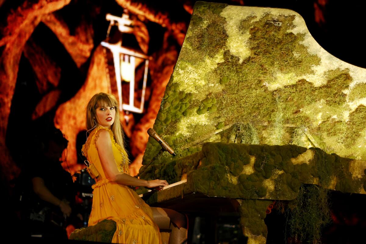 A pop star plays a mossy piano onstage.
