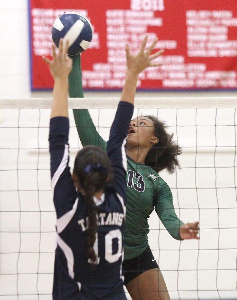 Sage Hill's Amiyah De'Long, right, kills a ball through the hands of a St. Margaret's middle blocker.