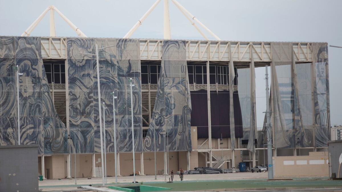 Tapestries fall from the exterior of Olympic Aquatic stadium in Rio de Janeiro, Brazil, on Feb. 4, just months after the 2016 Summer Games.