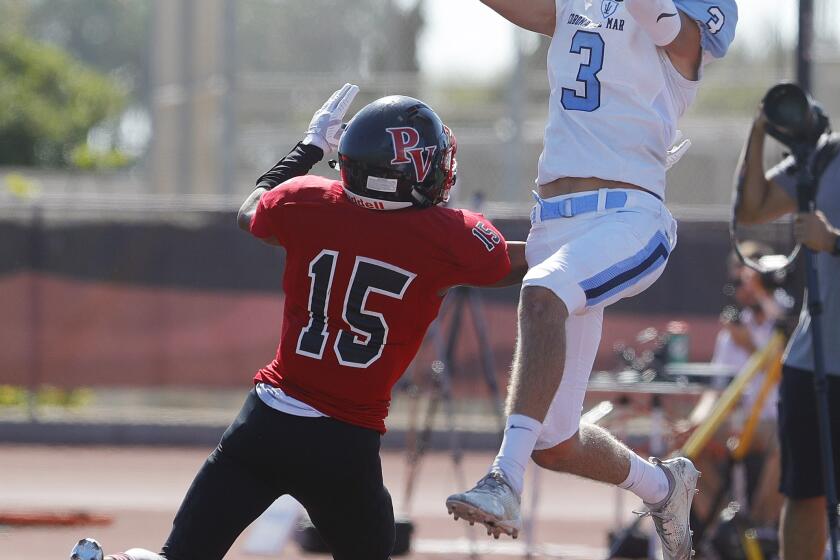 Corona del Mar's Tommy Griffin, at the back of the end zone, catches the football for a touchdown over Palos Verdes' David Lam in a non-league football game on Palos Verdes High School on Friday, September 6, 2019.