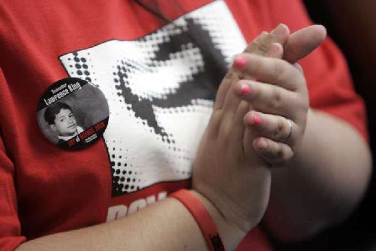 A student at Miguel Contreras High School in Los Angeles claps after a speaker commends students for involvement in a "Day of Silence" to protest the bullying of gay students.