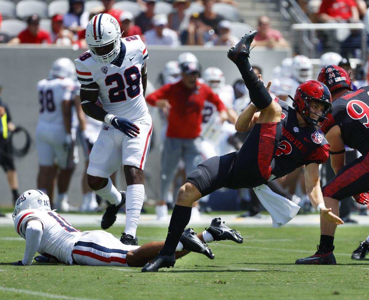 San Diego State's Jack Browning (13) has a punt blocked by Arizona's Dalton Johnson in the second quarter.