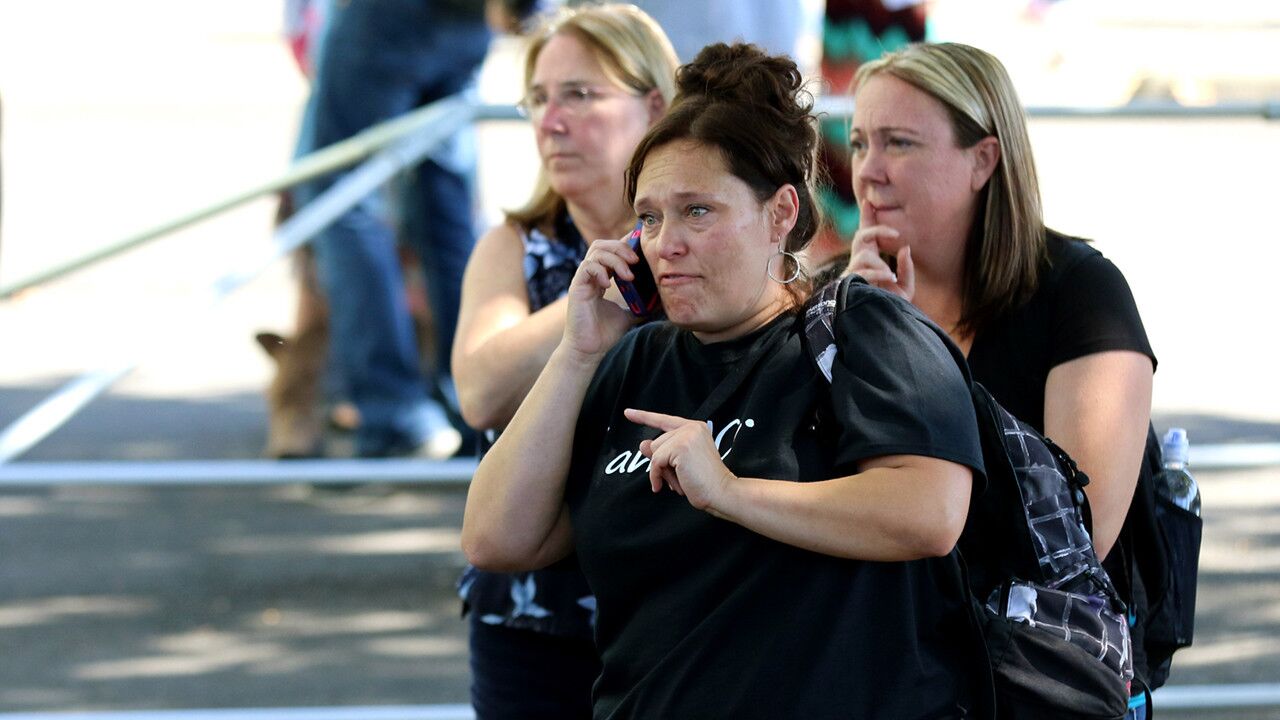 A woman speaks on her cellphone as friends and family are reunited with students at the local fairgrounds after a deadly shooting at Umpqua Community College in Roseburg, Ore. on Oct. 1.