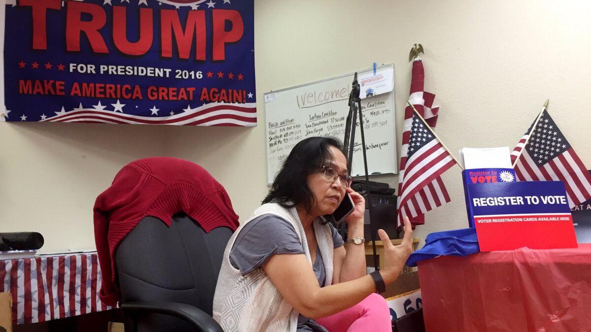 Rachel Gunther works phones at Trump headquarters located in an area colloquially referred to as "Cambodia Town, " in Long Beach, Calif.