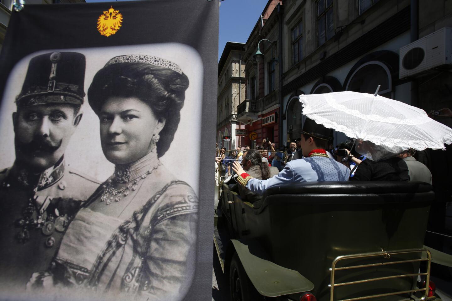 Tourists in Sarajevo pose for photographs inside a replica of the car in which Archduke Franz Ferdinand of Austria and his wife, Sophie, were assassinated on June 28, 2014.
