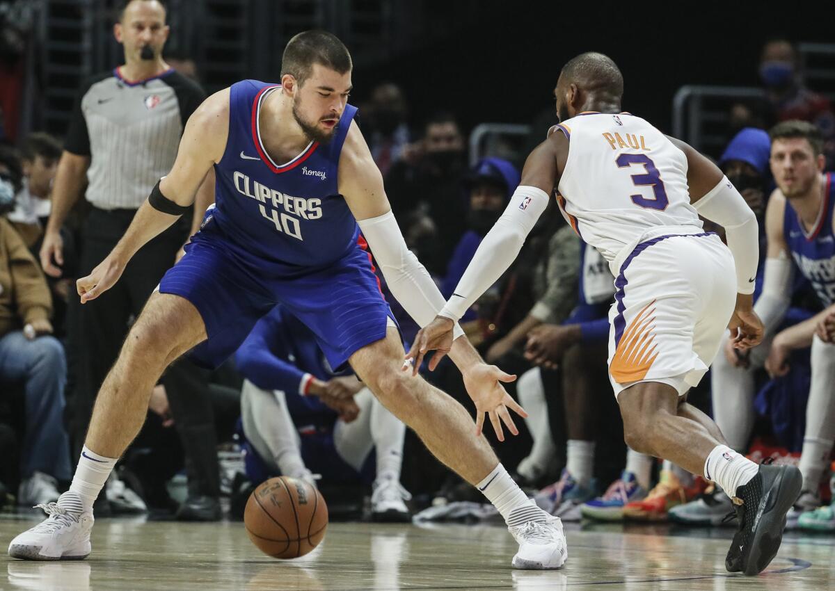 Clippers center Ivica Zubac, left, defends against Suns guard Chris Paul.