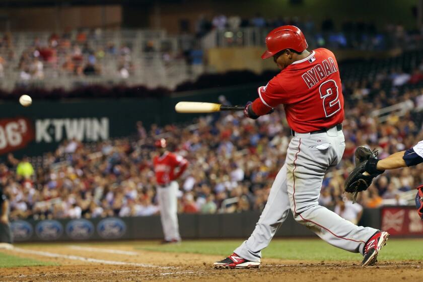 Erick Aybar hits a run-scoring single off of Minnesota's Kyle Gibson in the fourth inning of the Angels' 5-4 win Thursday over the Twins at Target Field.