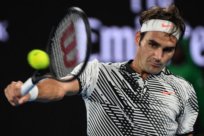 Roger Federer returns a shot against Rafael Nadal during the Australian Open men's final.