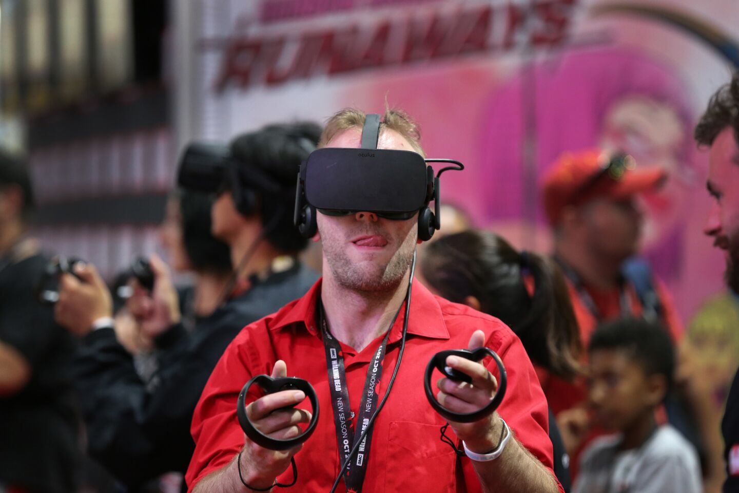 Karl Brevik of Colorado Springs, Col., joins fellow virtual reality players using the Oculus Rift VR headset with touch controllers and the Marvel Powers United VR.