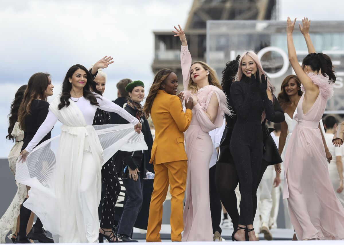 Aishwarya Rai Bachchan, from left, Helen Mirren and Amber Heard, fourth from left, wear creations for the L'Oreal Spring-Summer 2022 ready-to-wear fashion show presented in Paris, Sunday, Oct. 3, 2021. (Photo by Vianney Le Caer/Invision/AP)