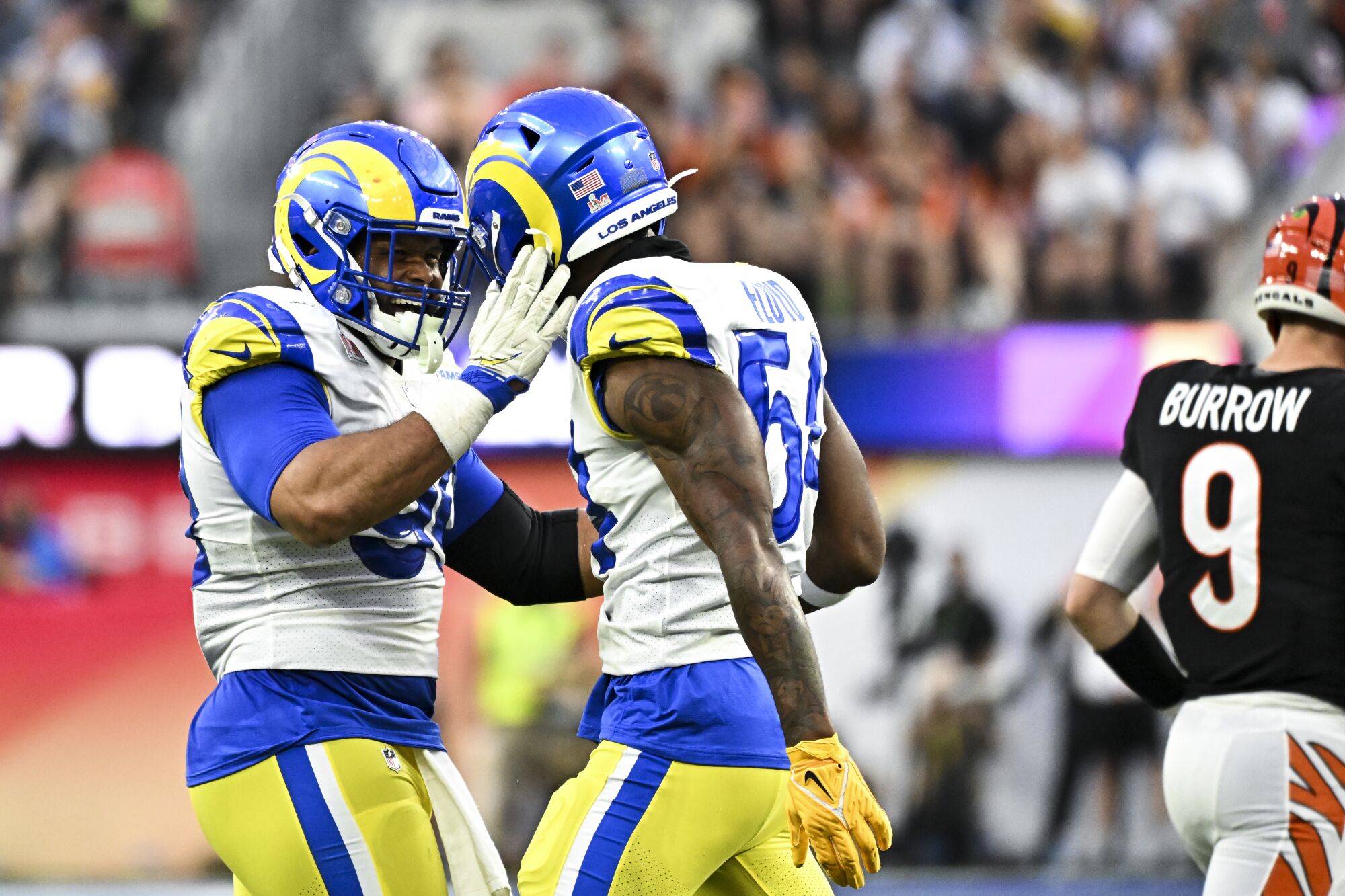 Rams defensive end Aaron Donald, left, celebrates with outside linebacker Leonard Floyd after a sack