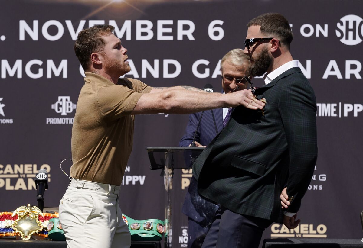 Unified WBC/WBO/WBA super middleweight champion Canelo Alvarez shoves undefeated IBF Super Middleweight Champion Caleb Plant