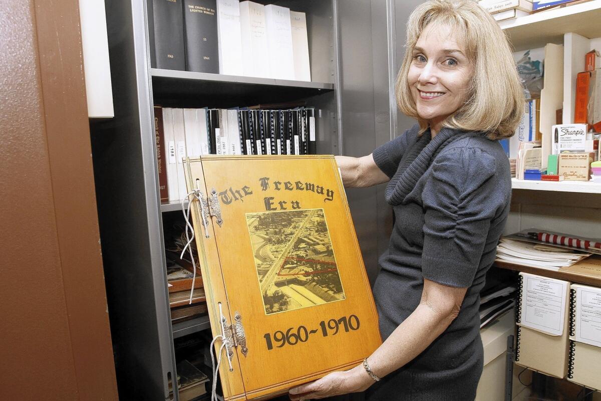 La Cañada Congregational Church book committee member Carol Kulluk shows a 50-year-old scrapbook at the church in La Cañada Flintridge on Tuesday, April 22, 2014.