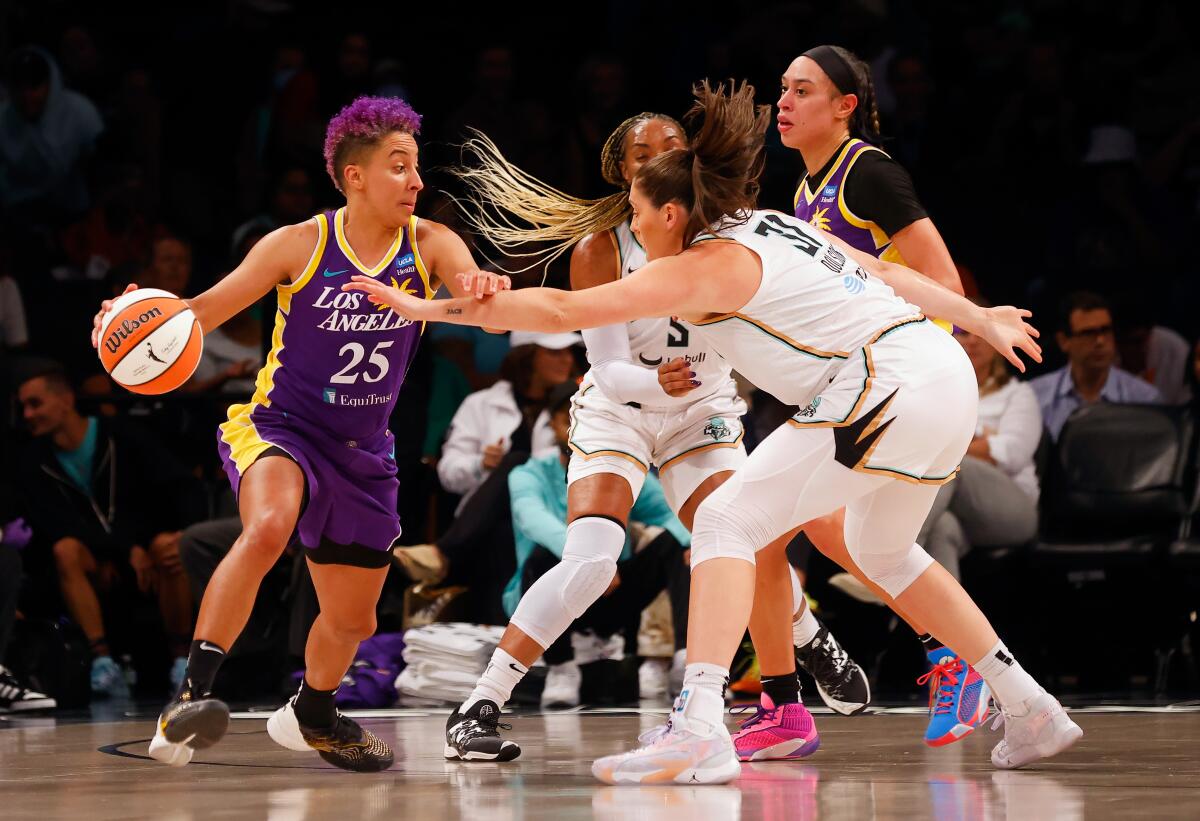 Sparks' Layshia Clarendon, left, controls the ball in front of New York's Stefanie Dolson.