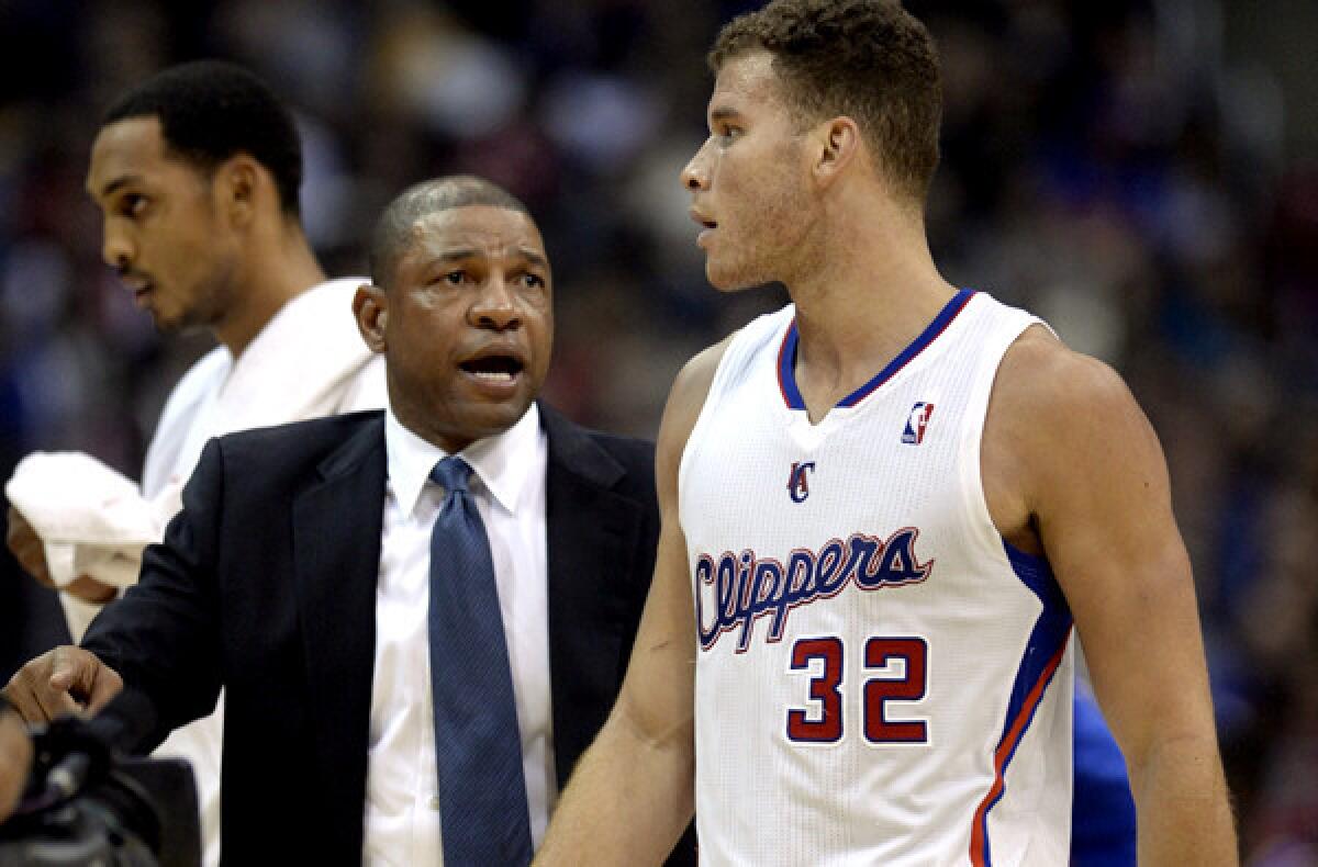 Clippers Coach Doc Rivers talks strategy with power forward Blake Griffin during a timeout in a recent game.