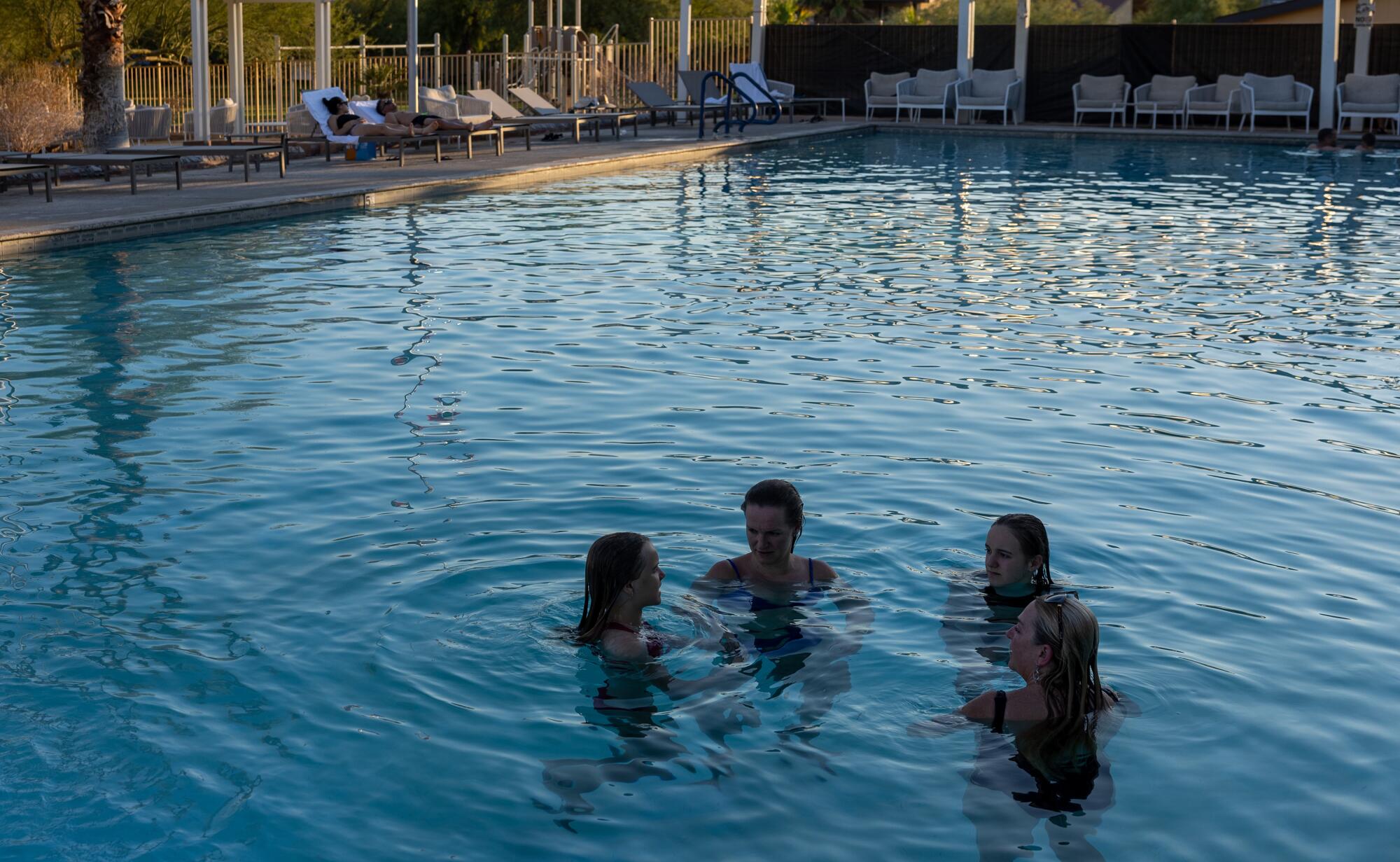 Four people in a pool.