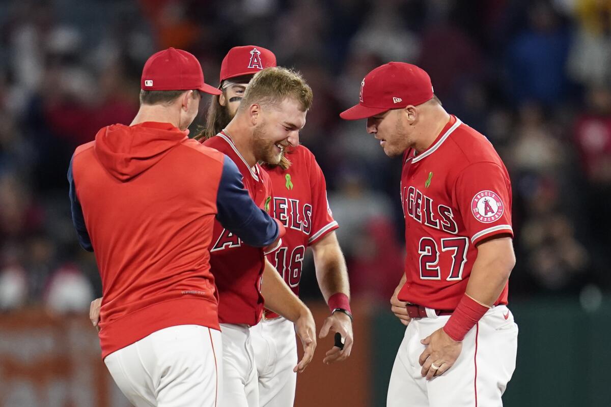 Los Angeles Angels starting pitcher Reid Detmers (48) celebrates with Mike Trout (27) after throwing a no hitter against the Tampa Bay Rays in a baseball game in Anaheim, Calif., Tuesday, May 10, 2022. The Angels won 12-0. (AP Photo/Ashley Landis)