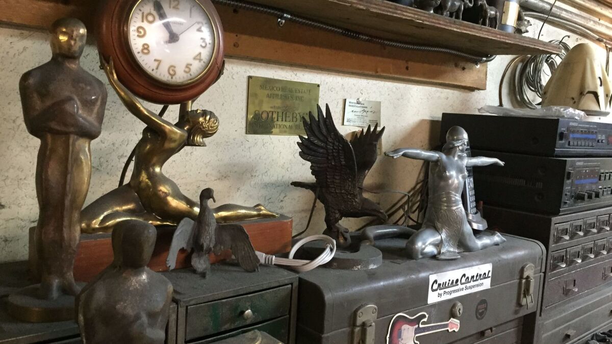 John Billings' workshop is littered with an eclectic array of statues and old trophies.