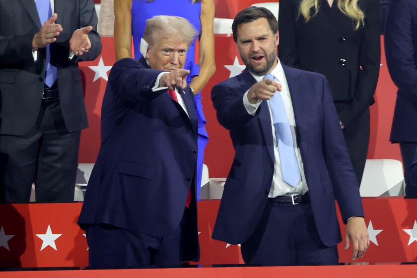 MILWAUKEE, WI JULY 15, 2024 -- Former US President Donald Trump, left, and J.D. Vance point to the crowd during the first day of the Republican National Convention at Milwaukee, WI on Monday, July 15, 2024. (Jason Armond / Los Angeles Times)