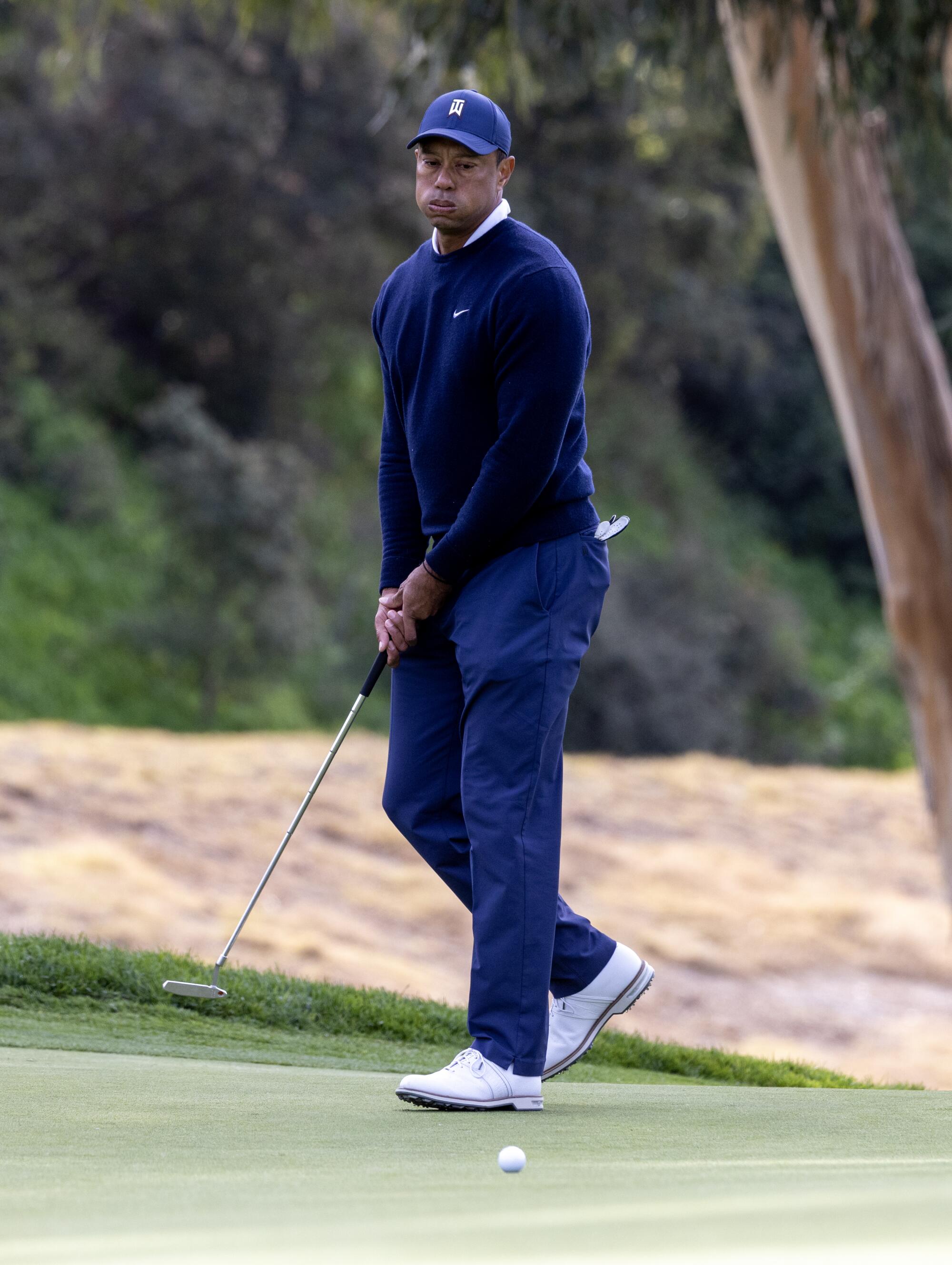 Tiger Woods reacts after missing a birdie putt on the seventh hole during the first round.