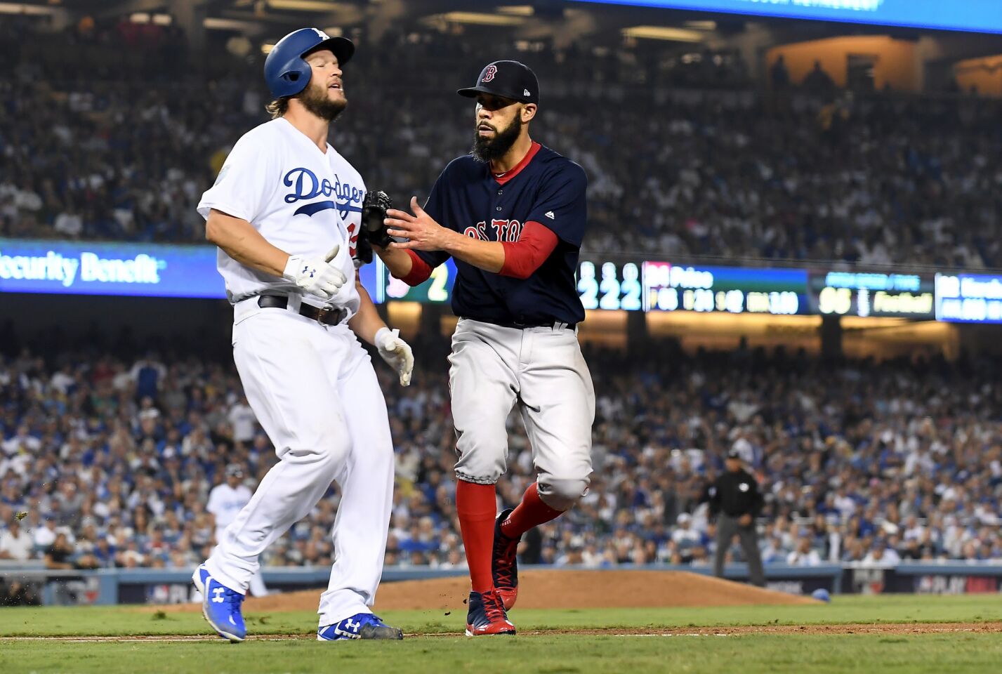 Dodgers pitcher Clayton Kershaw is tagged out by Red Sox pitcher David Price at 1st base to end the 5th inning.