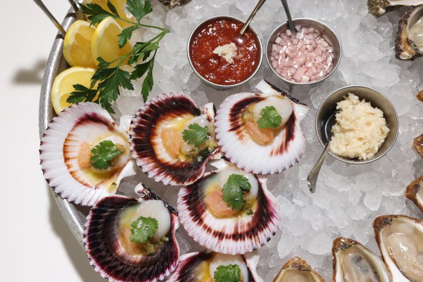 Los Angeles, CA - October 19: A mix of oysters and Peruvian scallops is served at Fishing With Dynamite restaurant on Wednesday, Oct. 19, 2022 in Los Angeles, CA. The restaurant is named as Los Angeles Times' best 101 restaurants of the year. (Dania Maxwell / Los Angeles Times)