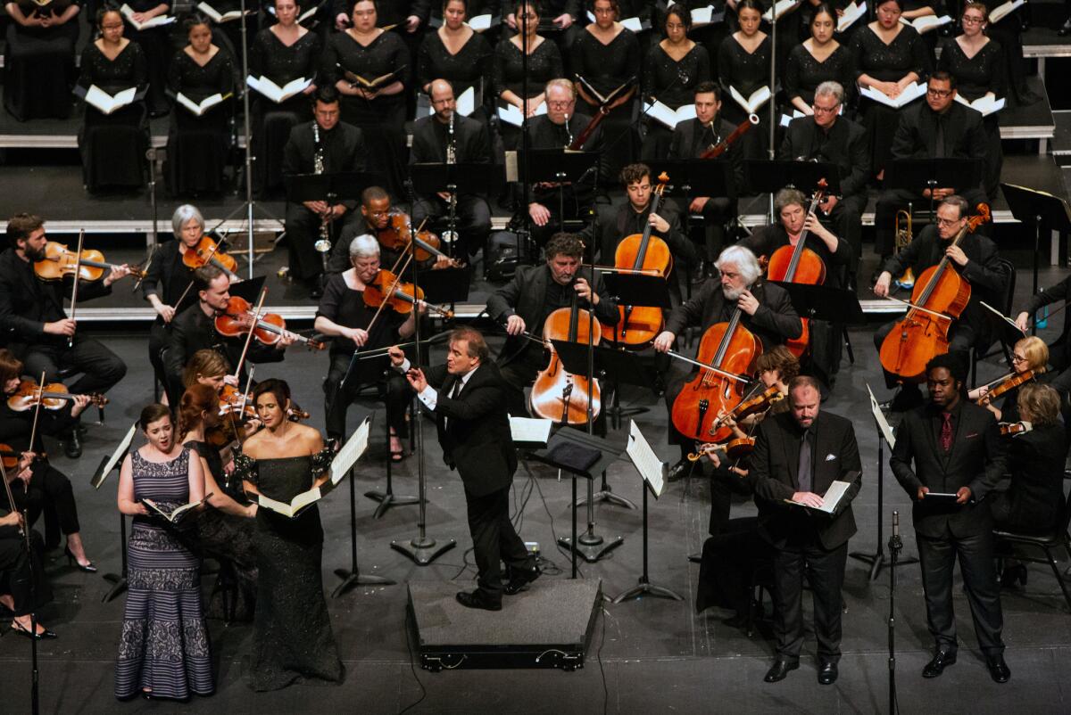 Spanish conductor Jaime Martín leads the Los Angeles Chamber Orchestra through Mozart's Requiem with singers, from left, Sarah Shafer, Kelley O'Connor, Thomas Cooley and Dashon Burton at UCLA's Royce Hall on Sunday.