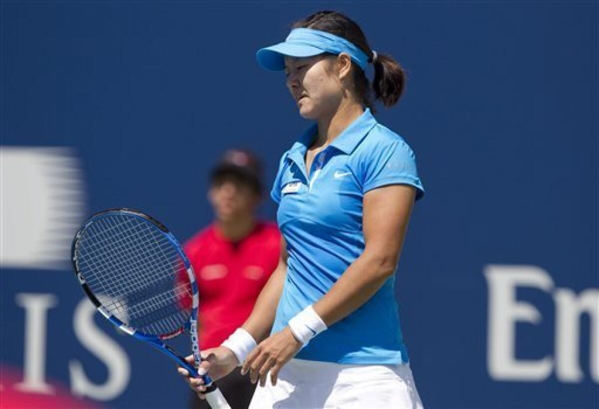 Li Na, of China, reacts to a lost point during 6-2, 6-4 loss to Samantha Stosur, of Australia, at the Rogers Cup women's tennis tournament in Toronto Thursday, Aug. 11, 2011. (AP Photo/The Canadian Press, Darren Calabrese)
