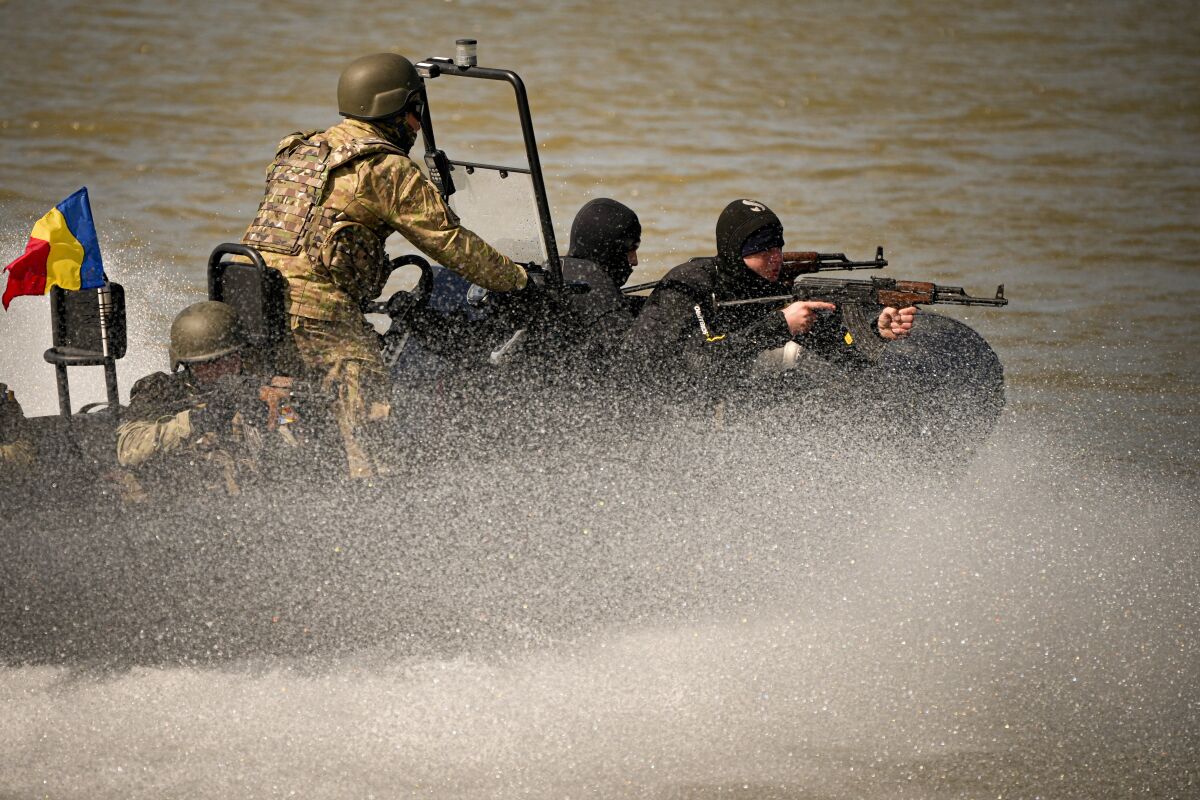 Naval commandos sail on the river Danube during a Romanian Navy led exercise outside Mahmudia, Romania, Thursday, March 30, 2023. The exercises, dubbed "Sea Shield 2023," brought together U.S. and NATO troops and involved some 3,400 military personnel from 12 NATO member countries and other partner states aims to enhance the "operational and tactical interoperability" of the multinational forces.(AP Photo/Andreea Alexandru)