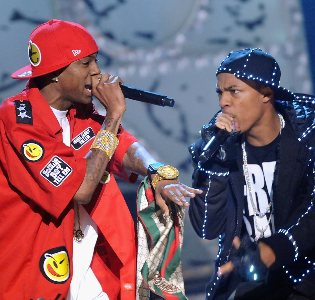 Two men rap side by side at a live event.