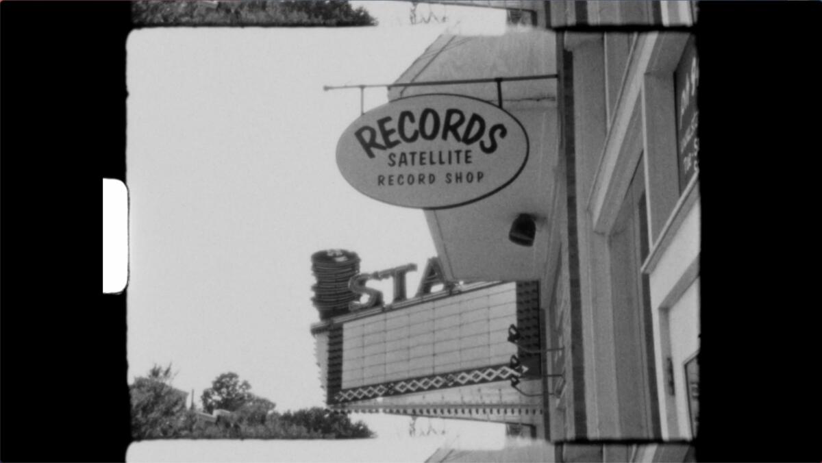 A black-and-white image of the Stax marquee and a record shop sign.