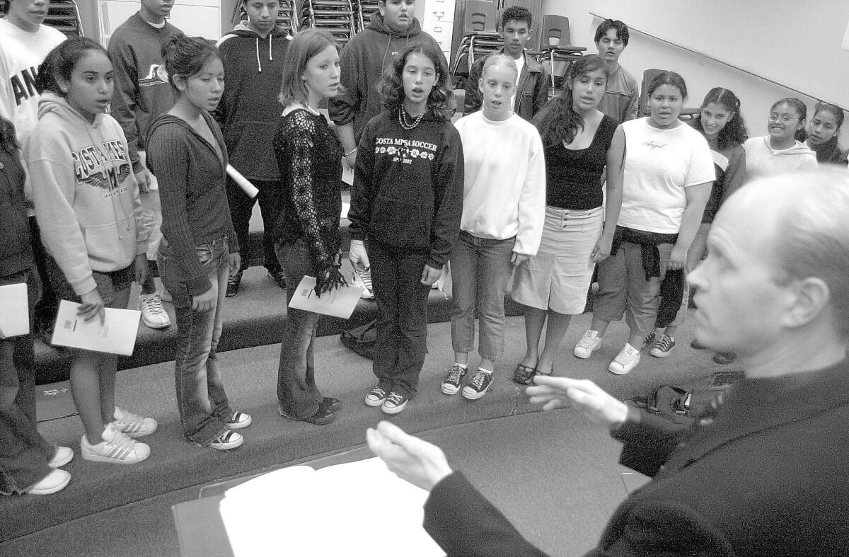 Photographed in 2002, the Costa Mesa High School Concert Choir rehearses under the direction of Jon Lindfors for a concert at the South Coast Repertory Theatre.