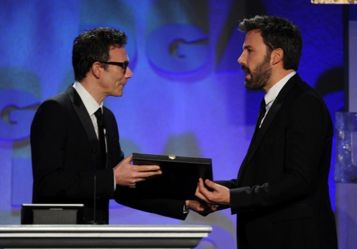 Michel Hazanavicius, left, presents Ben Affleck with the award for achievement in feature film for "Argo" at the 2013 Directors Guild of America Awards on Feb. 2.