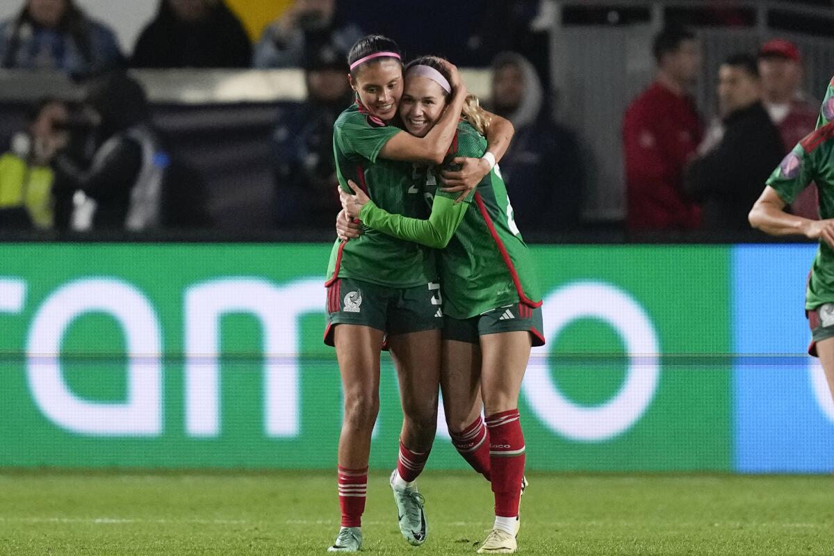 Mexico midfielder Mayra Pelayo, right, celebrates with teammate Karen Luna after scoring against the U.S. on Monday.
