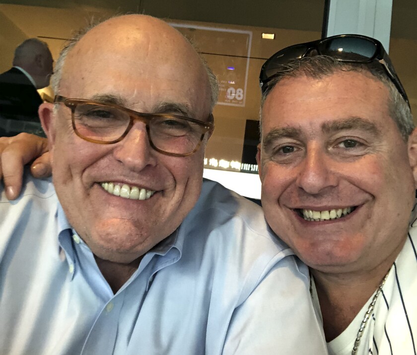 President Trump's attorney Rudolph Giuliani, left, with Lev Parnas. Parnas can be heard talking with President Trump in a newly released recording of a 2018 meeting; Trump recently denied knowing him.