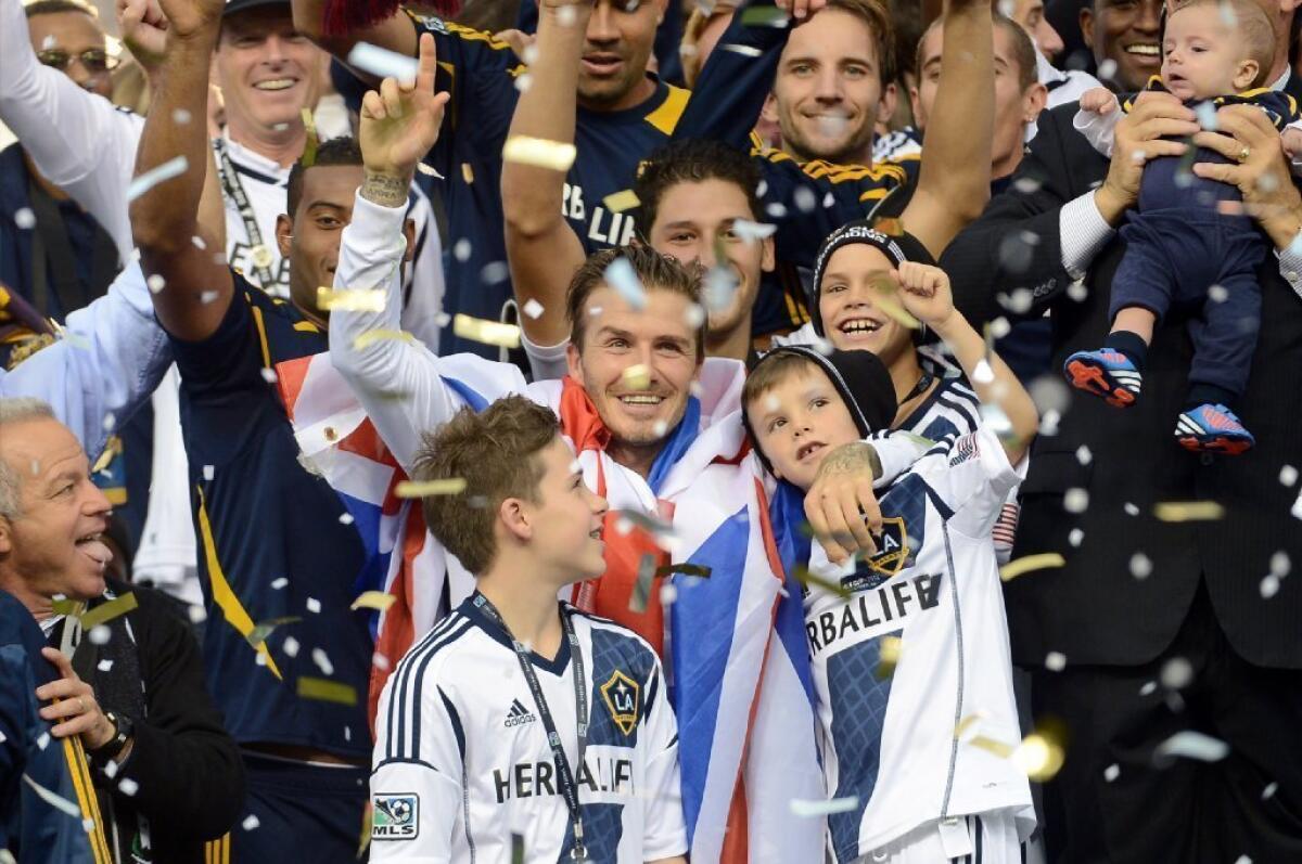 David Beckham celebrates with his sons after the Galaxy defeated the Houston Dynamo, 3-1, to win the 2012 MLS Cup at Home Depot Center.