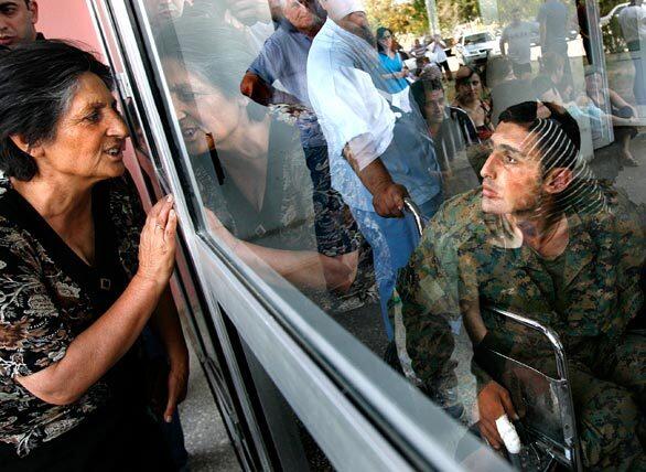 Giorgi Ramazahshvili, 21, greets a relative after arriving at Ghudushauri Hospital. Ramazahshvili was one of 15 Georgian captives who was exchanged for five Russian prisoners during an hand-off.