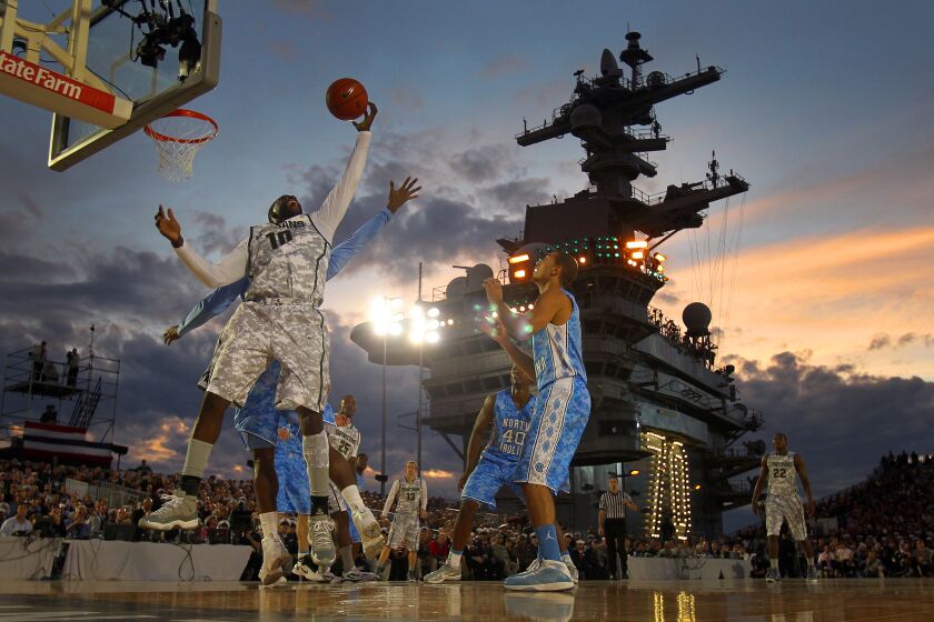 | Michigan State's Draymond Green grabs a rebound against North Carolina' during the Carrier Classic on the deck of the USS Carl Vinson on Friday, Nov. 11, 2011. | (Photo by K.C. Alfred / The San Diego Union-Tribune)