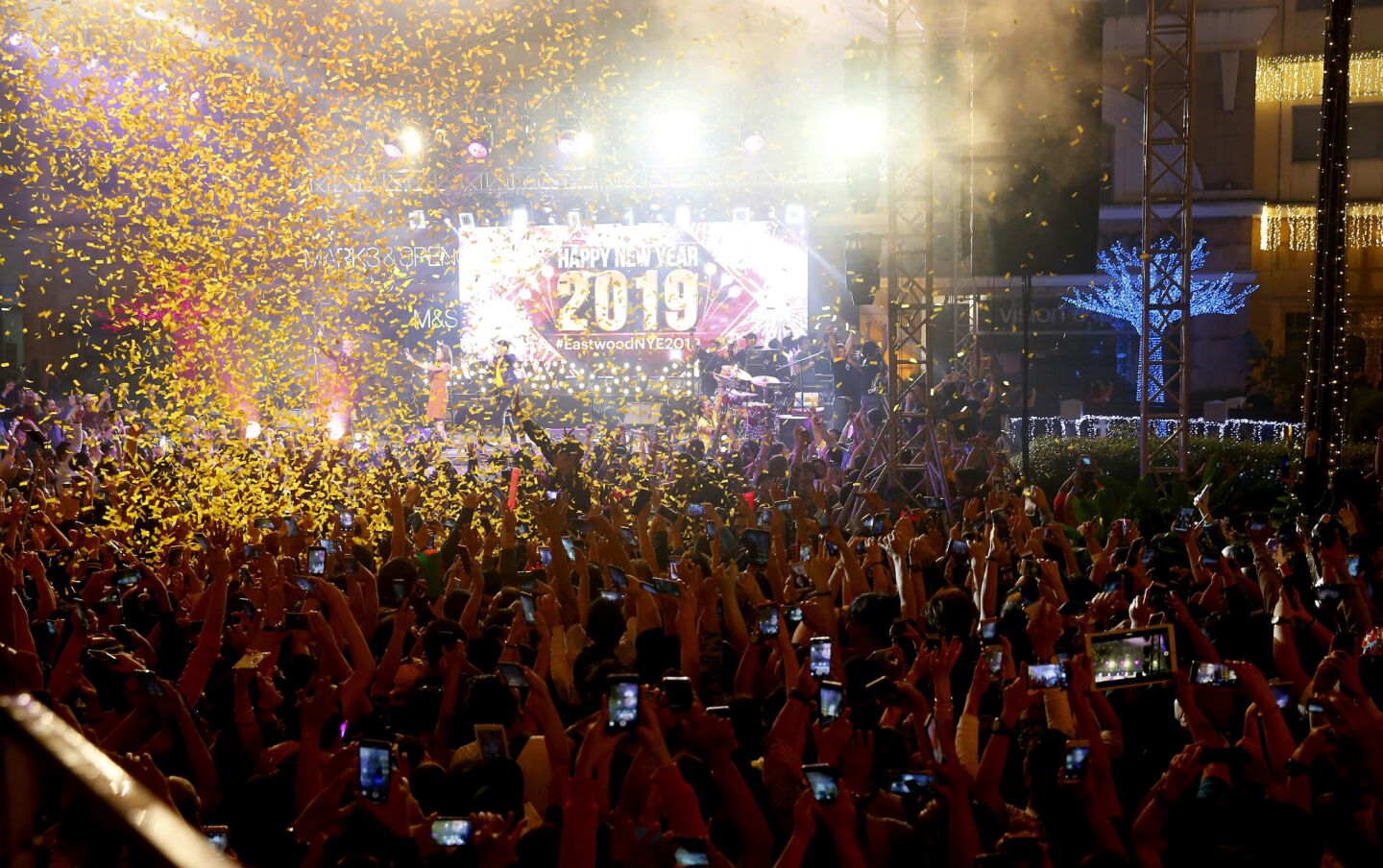 Confetti rains down on revelers at a mall in Quezon City, northeast of Manila, as Filipinos welcome the new year.