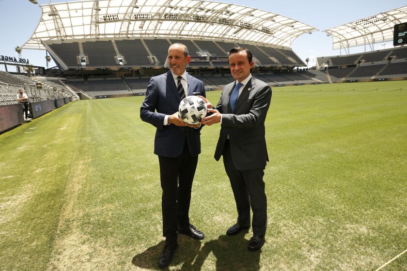 LOS ANGELES, CA - JUNE 09: Don Garber, left, Commissioner of Major League Soccer MLS with Mikel Arriola, right, LIGA MX Executive President, pose for photos following a press conference to announce the MLS All-Star Game will be played at the Banc of California Stadium in Los Angeles. Banc of California Stadium on Wednesday, June 9, 2021 in Los Angeles, CA. (Al Seib / Los Angeles Times).