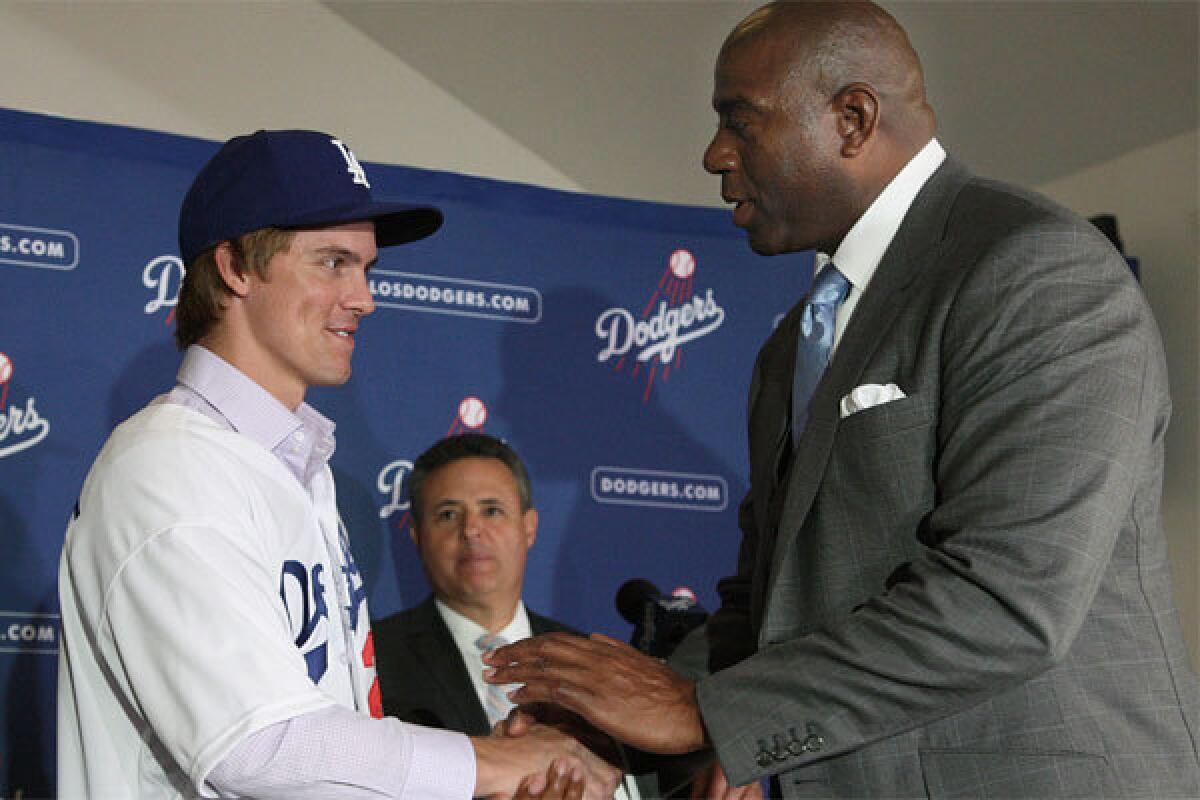 Zach Greinke, left, with co-owner Magic Johnson, is one of the many free-agents the Dodgers signed with an eye on a World Series championship.